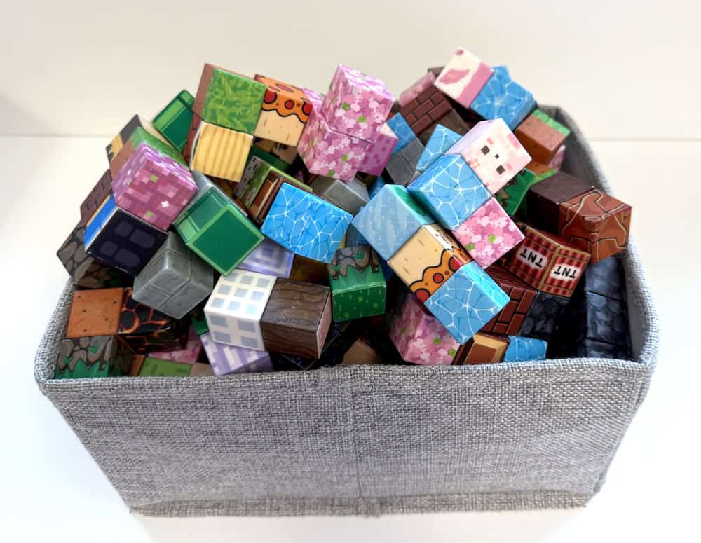 A fabric basket filled with various Minecraft-themed blocks and cubes, each displaying different textures and patterns, makes for a perfect early finisher idea. Add magnetic building blocks to enhance creativity and fun.