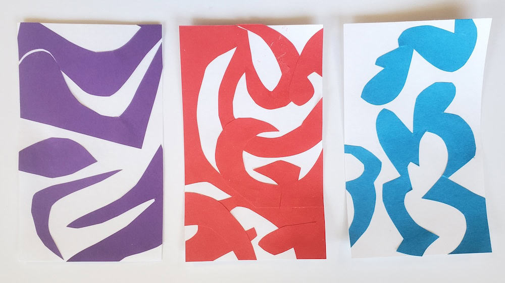 Three abstract cutouts on paper: purple on the left, red in the center, and blue on the right. Each art piece features curved shapes on a white background, reminiscent of timed collage prompts for creative expression.